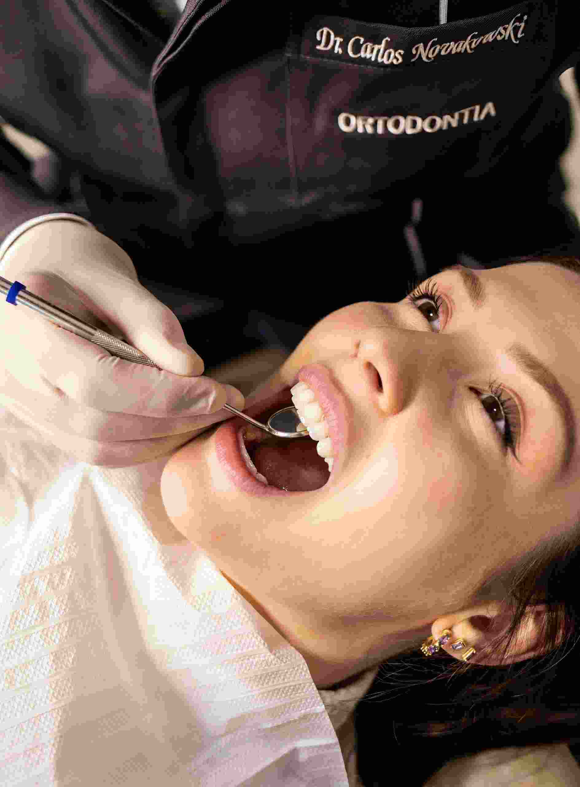 Patient receiving a dental examination from a specialist, illustrating Dentist loan opportunities, dental specialty practice loans, dental office real estate loans, dental operating capital, and dental office growth capital used to expand and modernize dental practices.