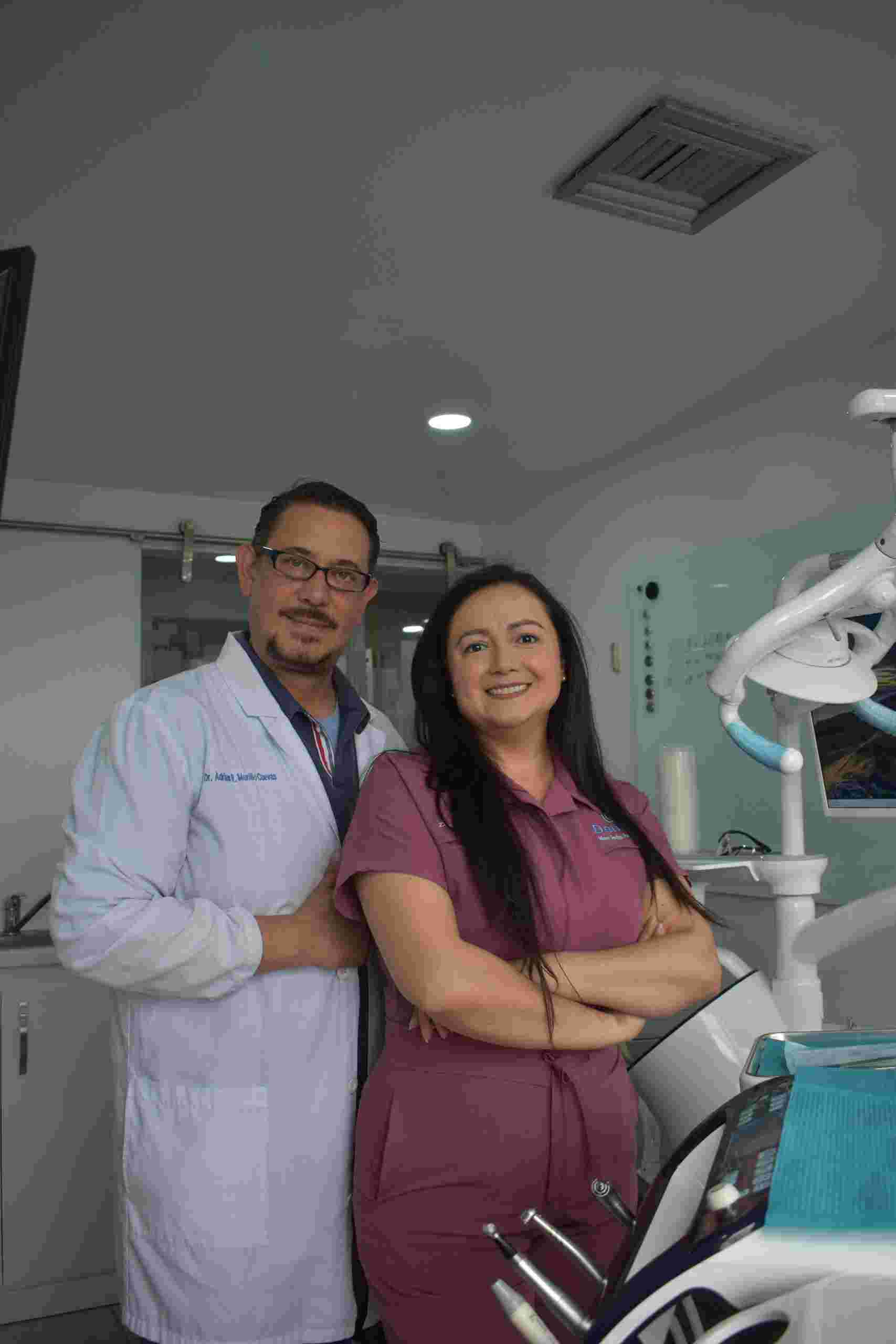Dentist and dental office manager standing in a modern treatment room with advanced equipment, representing Dental Financing, Dental Business Line of Credit, Dentist Acquisition Funding, Dental Partnership Buy In Financing, and Orthodontic Office Funding for practice growth and expansion.