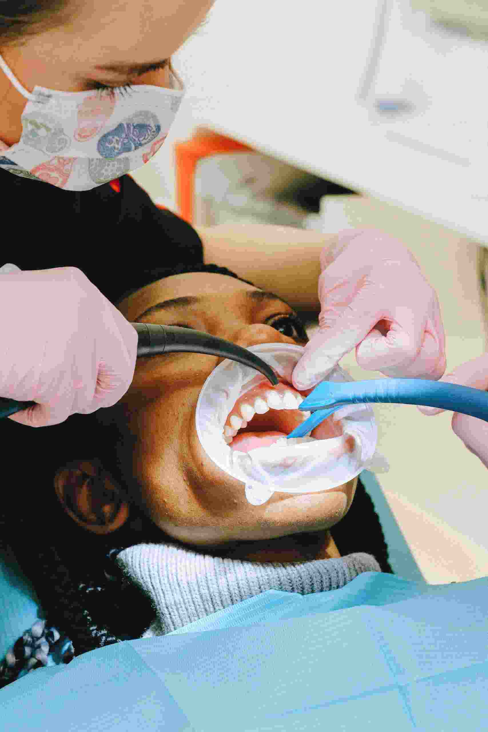 Young dental patient receiving treatment in a modern pediatric dental office equipped with advanced technology and imaging systems, representing Dental Building Financing, Cosmetic Dentistry Financing, Prosthodontic Practice Financing, Dental Facility Expansion Loans, and Dental Scanner Financing for growing dental practices.