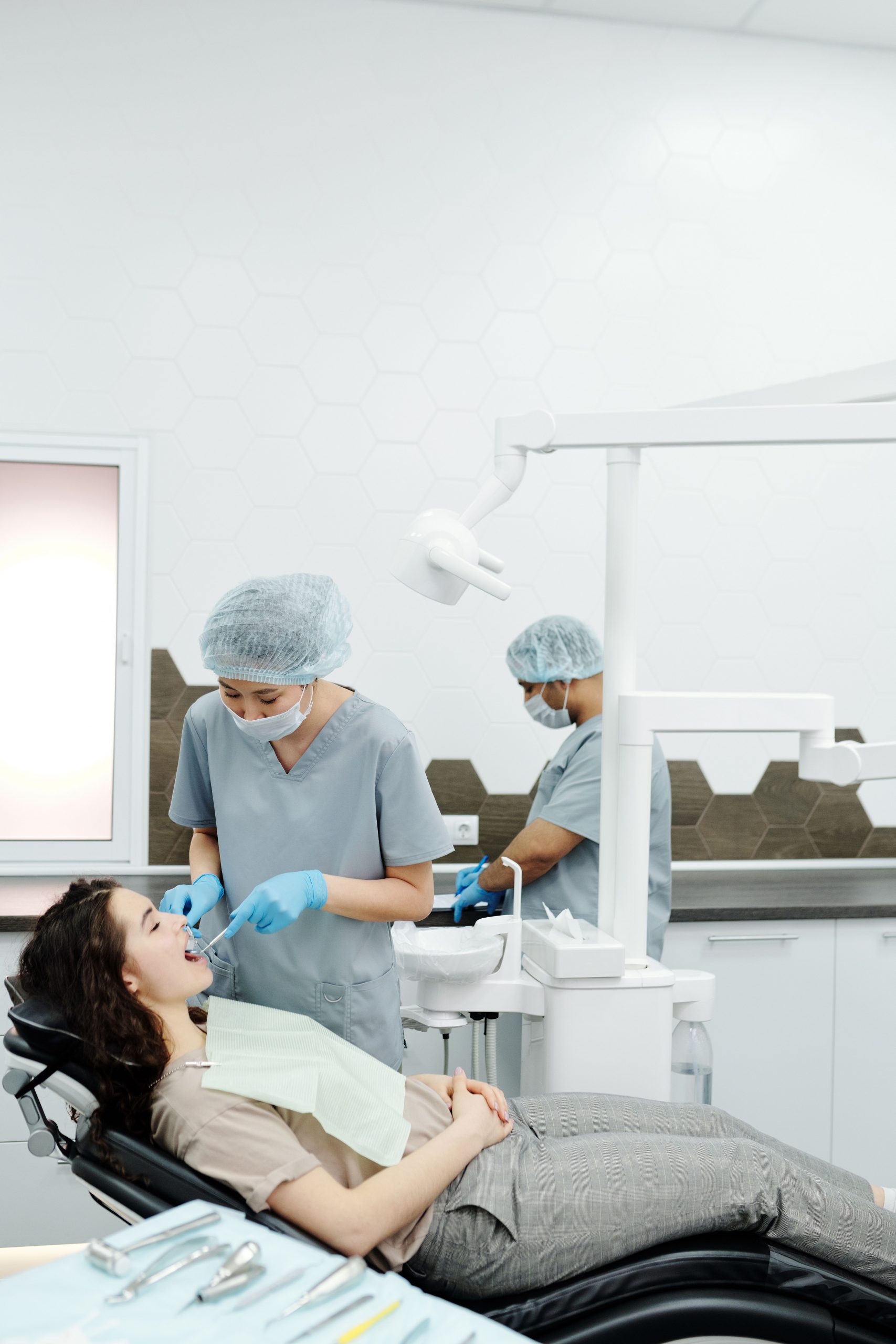 Modern periodontal dental practice with clinicians treating a patient in a fully equipped operatory, showcasing advanced care supported by Periodontist Practice Financing, Periodontal Equipment Financing, Surgical Dental Equipment Loans, Dental Office Operating capital, and specialized Dental Financing Companies.