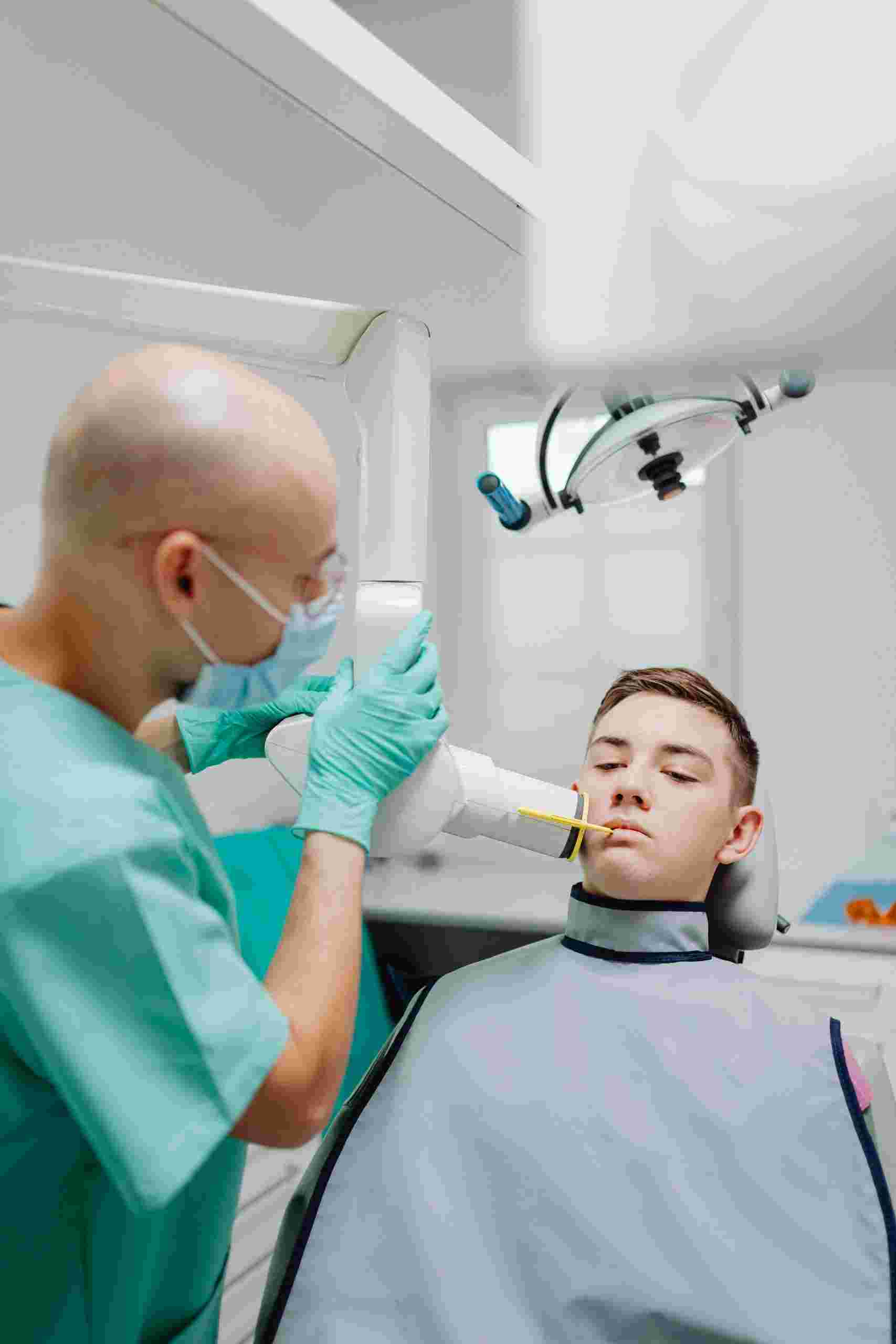 Dentist performing a digital dental scan on a patient using advanced imaging technology, highlighting Dentist loans, orthodontic startup financing, endodontic practice financing, dental clinic expansion funding, and dental practice scaling financing for modern dental practice growth.